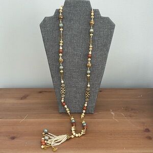 Long earth tone beaded necklace with tassel and gold details